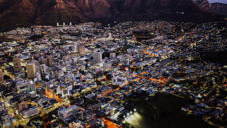 A stunning aerial view of Cape Town city lights at night against Table Mountain.